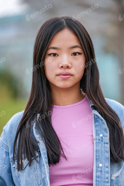 Preview: Portrait of young Asian woman posing outdoors.