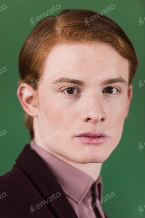 Preview: Portrait of young male fashion model isolated on green