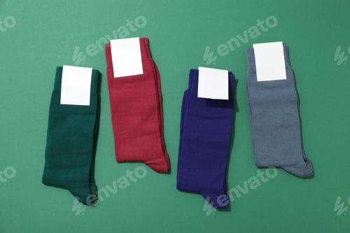 Preview: Multicolored high socks on a green background.