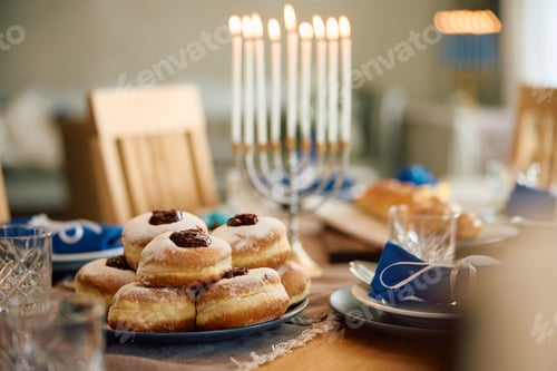 Preview: Traditional Jewish jam filled donuts on dining table.