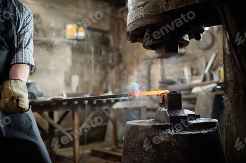 Preview: Man forging the iron in the workshop