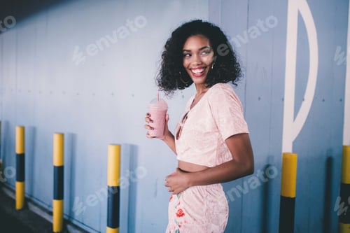 Preview: Smiling Woman Poses with a Pink Smoothie