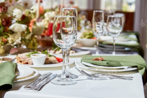 Preview: Within the elegant chamber, a finely set table showcases a harmonious blend of candles and flowers
