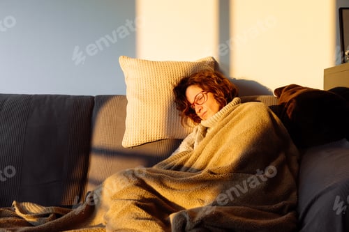 Preview: Young woman sleeping on sofa