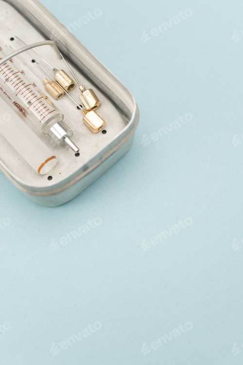 Preview: isolated sterilized glass injection syringe in a box on a blue background