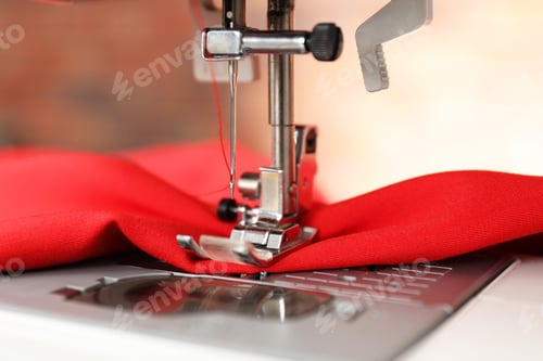 Preview: Sewing machine with red fabric indoors, closeup