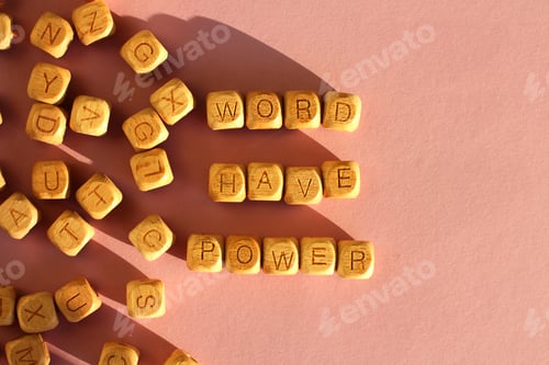 Preview: wooden cubes with the inscription world have power on a pink background. selective focus