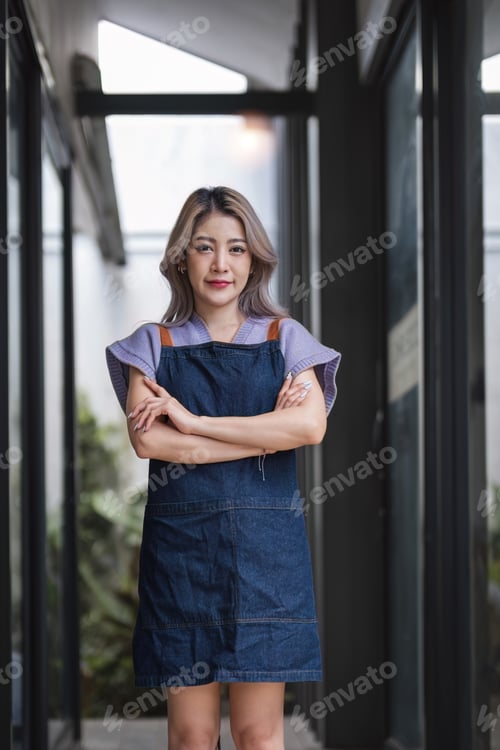 Preview: Opening a small business, A Happy Asian woman in an apron standing near a bar counter coffee shop