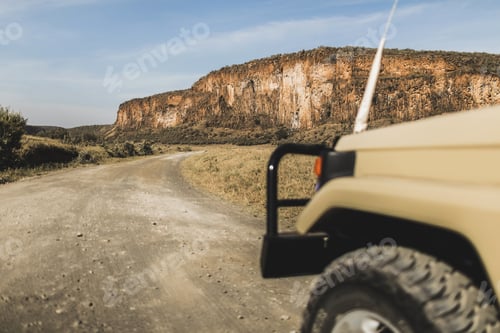 Preview: Safari in Hell's Gate national park in Kenya. Off road jeep car, savannah and mountain view