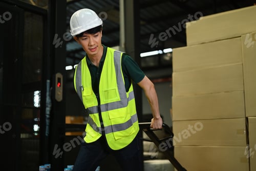 Preview: Warehouse worker pulling pallet truck stack with boxes.