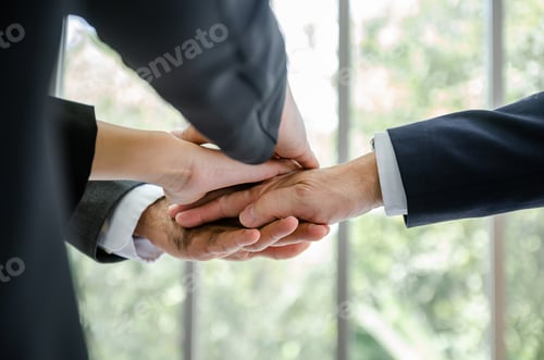 Preview: close up business people putting their hands together.Unity and teamwork concept