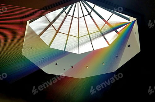 Preview: Creative Minds: Rainbow colored string hung beneath octagonal sun light in roof of museum.