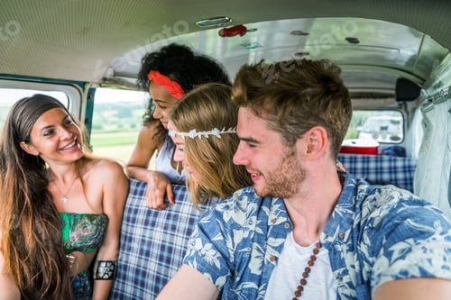 Preview: Happy friends driving a vintage minivan