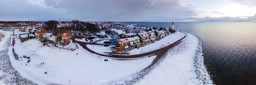 Preview: panoramic view of the Lighthouse of Urk during winter with snow in the Netherlands