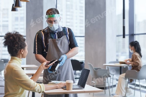 Preview: Young African American Woman Paying in Cafe