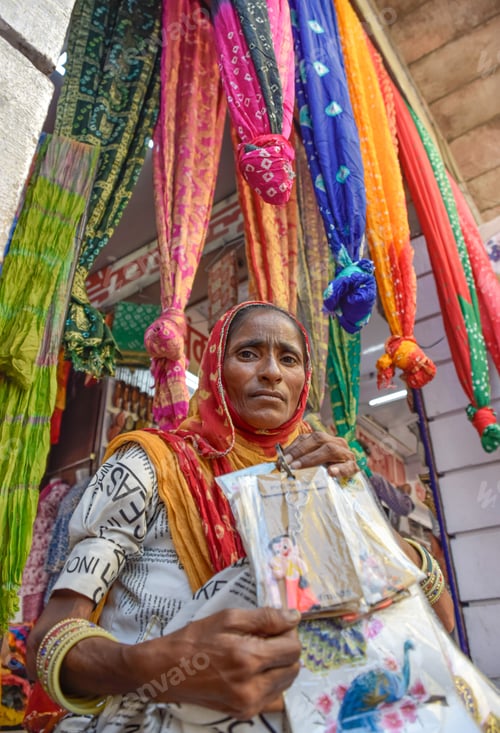 Preview: Indian Woman with beautiful face posing with textiles in background