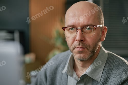 Preview: Portrait of Middle Aged Caucasian Man Wearing Glasses Working at Computer