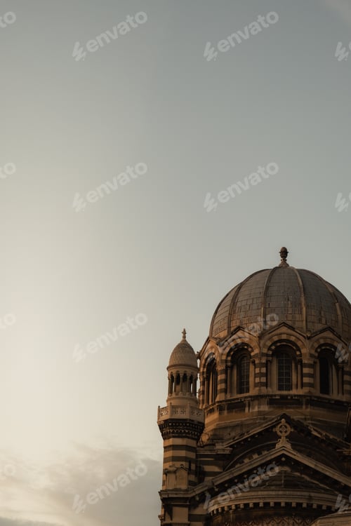 Preview: Large dome building with a small adjacent tower against a clear sky
