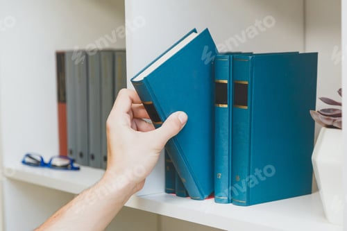 Preview: Hand taking book from the shelf