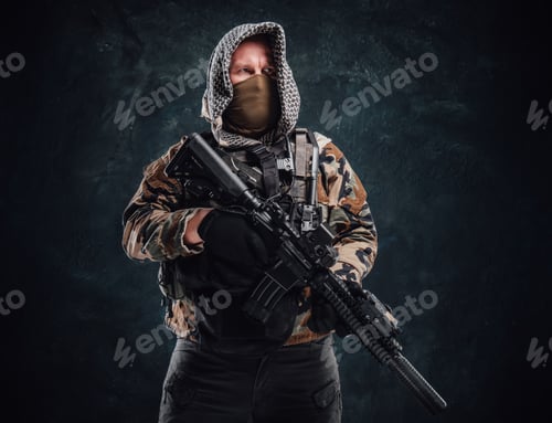 Preview: Special forces soldier dressed in military clothing and holding a rifle