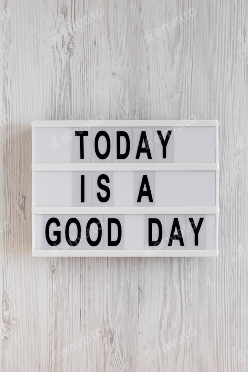 Preview: 'Today is a good day' words on a lightbox on a white wooden background, top view.