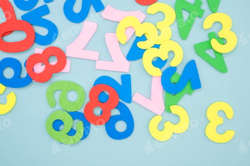Preview: Top view of the colorful wooden numbers scattered on a blue surface