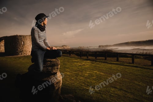 Preview: Woman and sitting on bench on shore near water