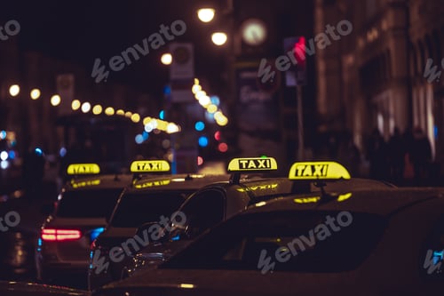 Preview: Yellow TAXI signs on the taxis captured at night