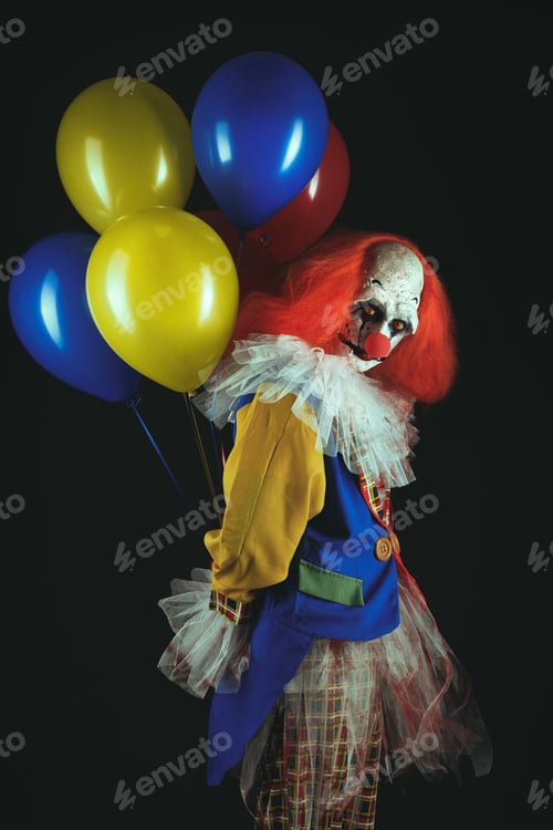 Preview: Terrifying clown with air balloons on black background. Halloween party costume