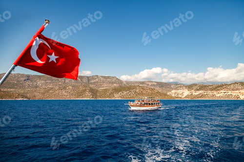 Preview: Yacht under the Turkish flag in the Mediterranean. Beautiful view of Kemer mountains