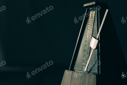 Preview: Vintage metronome, on a dark background.