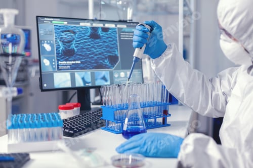 Preview: Laborant dropping sample in test tube using micropipette