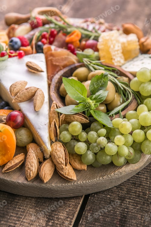 Preview: Antipasto background. Different Italian snacks with fruit, nut on a rustic background.