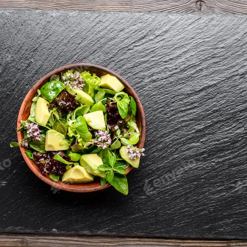 Preview: Top view at clay dish with salad of avocado, green and violet le