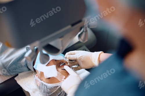 Preview: Close up of woman being prepared for laser eye surgery at the clinic.