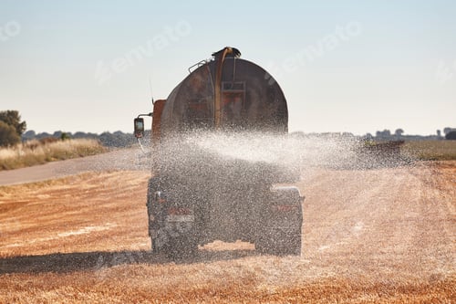Preview: Truck irrigating a wheat field with fresh water. Efficiency agriculture