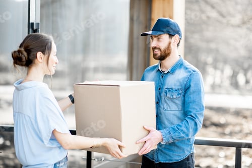 Preview: Delivery man bringing goods home for a woman client