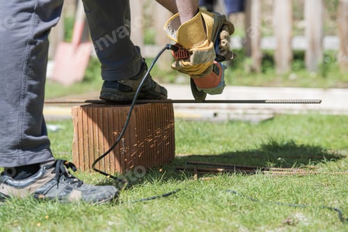 Preview: Man cutting steel rod, working on a back yard project