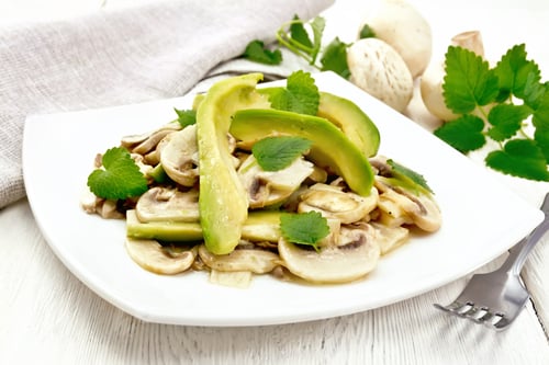 Preview: Salad of avocado and champignons on table