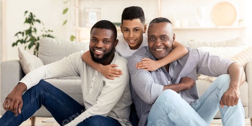 Preview: Portrait of happy preteen black boy hugging father and grandpa at home