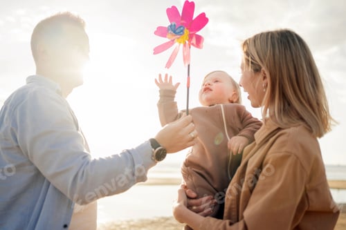 Preview: Happy family parents dad, mom and daughter, relaxing holidays walking on the beach.