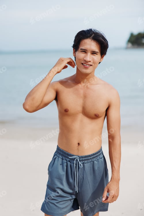 Preview: Muscular Asian Man Running Along Beach at Sunset, Exuding Strength and Vitality
