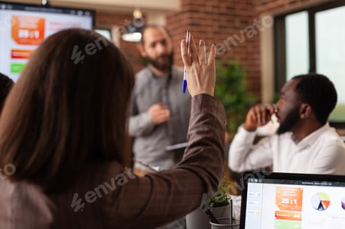 Preview: Businesswoman having rising hand having marketing question during business meeting