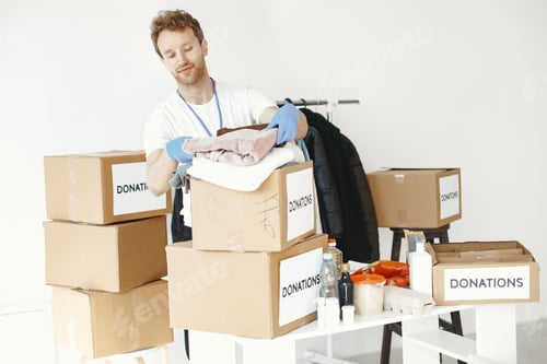 Preview: Volunteer guy packs boxes with a humanitarian help