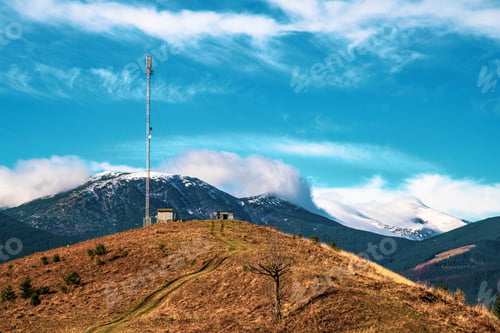 Preview: Telecommunication tower against the backdrop of an awesomely beautiful sky with blurry snow-white