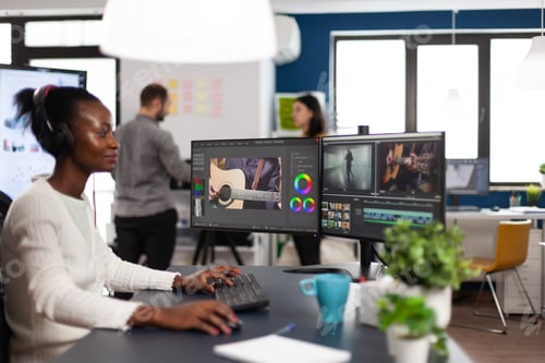 Preview: African videographer wearing headset editing movie