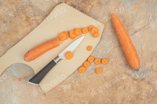 Preview: A wooden cutting board with sliced carrot and knife