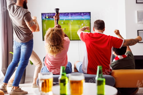 Preview: Friends cheering while watching football on TV