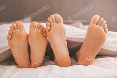 Preview: Feet of couple in comfortable bed
