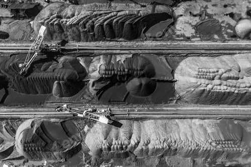 Preview: Aerial shot of black coal deposits with machines in the field